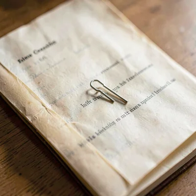 Macro of a folded translation manuscript with a paperclip, vellum translucency