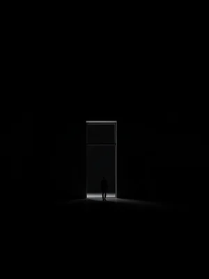 Doorway of light in an otherwise completely dark room, small figure approaching