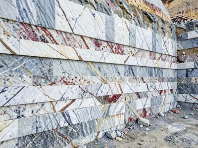Quarry wall showing horizontal extraction layers as stripes