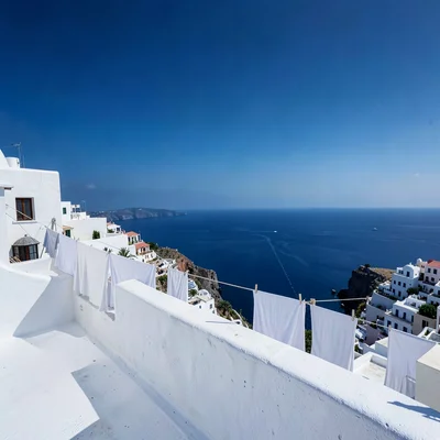 Sidi Bou Said cobalt-white, cliff-top absolute palette, White sheets drying on r