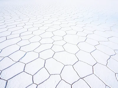Aerial view of salt flat hexagons — geometric polygon cracking pattern across th