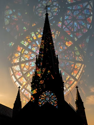Church steeple silhouette merged with stained glass kaleidoscope, double exposur