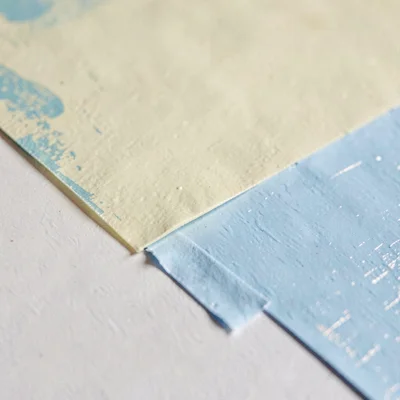 Surface study of a masking-tape edge against fresh paint, crisp line