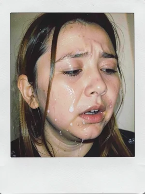 The moment right before crying, face half-turned away, Polaroid chemicals bloomi