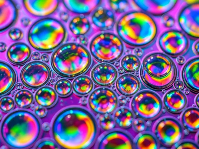 Cooking oil cells on water surface with rainbow illumination beneath