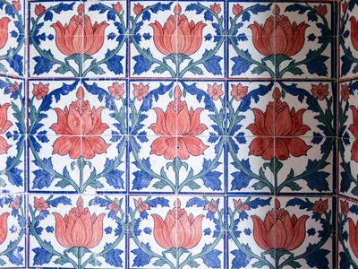 Repeating tile wall detail from a mosque interior — offset panels, bold coral tu