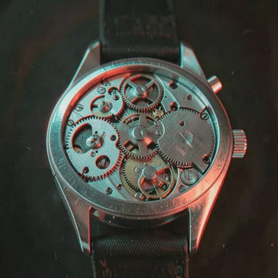A mechanical watch movement from above, gears and springs at different heights e