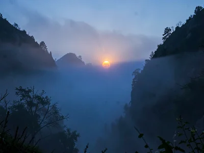 Sun disk visible through moderate fog depth