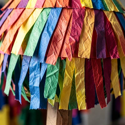 Close-up of the fringe tissue paper decoration on a finished piñata — layered cu