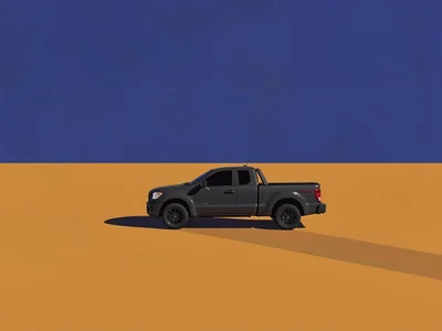 Speck of a charcoal pickup truck crosses a vast ochre plateau under a deep lapis