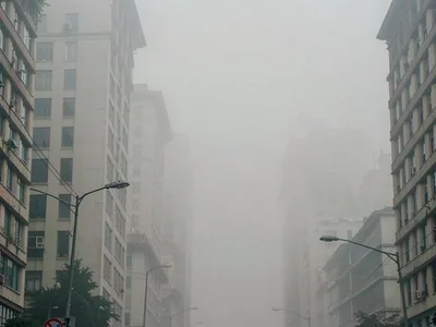 Urban canyon in smog filling