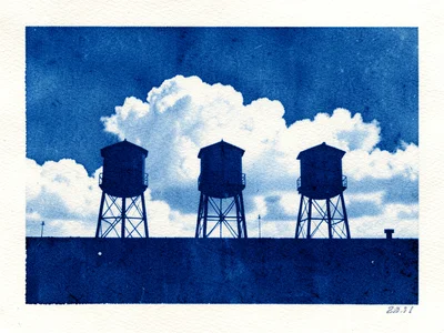 Three water towers on a rooftop skyline silhouetted against clouds