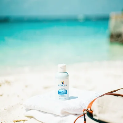 Expansive turquoise negative space, bleached whites, Sunscreen bottle on white t
