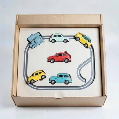 Block-color flat of a starter set unboxed — engine, three cars, oval track loop
