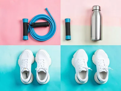 Workout flat-lay a coiled jump rope folded resistance band, a steel water bottle