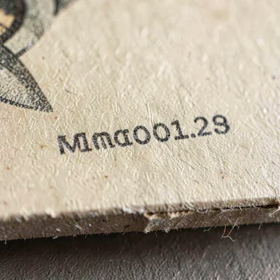 Mineral close-up of a hand-numbered edition mark in graphite along the lower mar