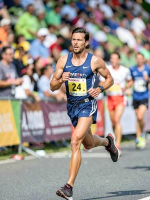Marathon runner at mile 24, the determination blurred but the effort clear