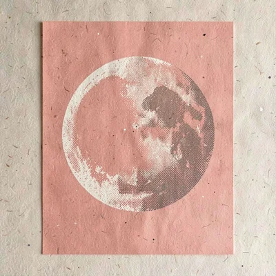 Bold screenprint poster of a halftone moon silhouette in coral over flat oat pap