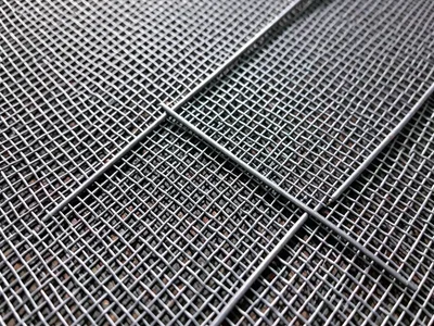Double-layer wire mesh, two screens overlapping at slight angle creating moiré i