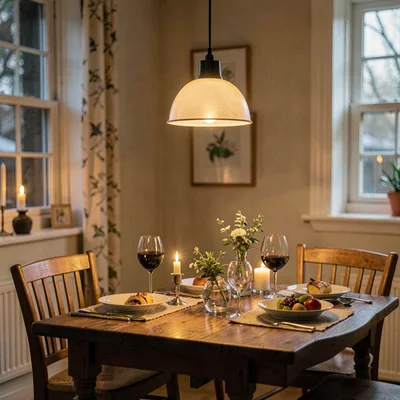 Cozy story tile of a pendant hanging over a small dining table at dinner, low go