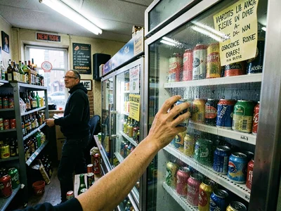 Drink cooler selection, reach in for cold can, condensation on glass