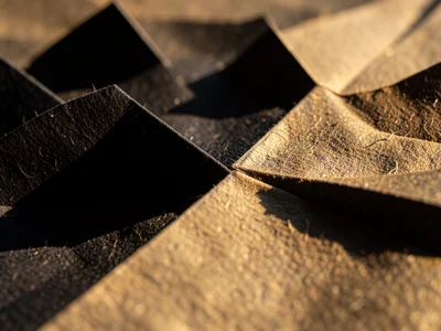 Origami bats in black paper, flock arrangement, shadow detail, macro