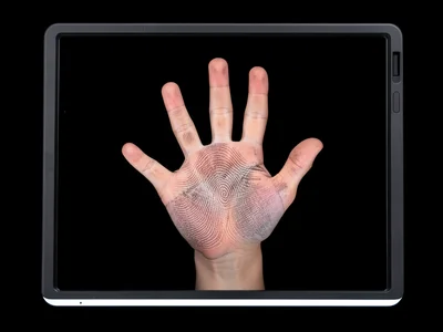 Hand pressed flat on scanner glass, skin compressed against glass showing finger