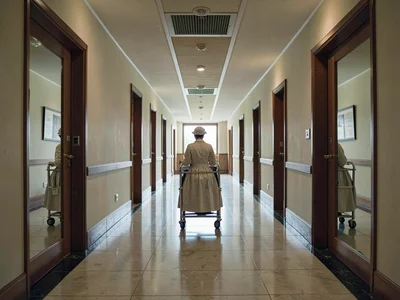 Hotel hallway infinite in both directions, maid cart precisely between two doors