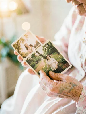 Grandmother's hands holding vintage photographs