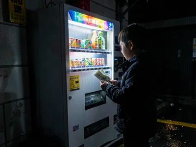 Child with dollar bill too wrinkled for machine, face lit by rejection, the firs
