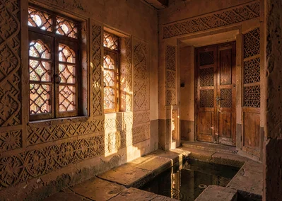 Colored light through qamariya windows in Sana'a, Yemen, geometric plaster friez