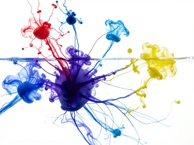 Multiple drops of different colors: red, blue, yellow — each diffusing independe