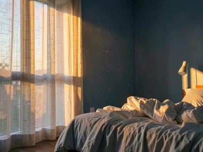 Minimalist bedroom morning light wide shot