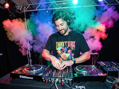 DJ at booth with color wash