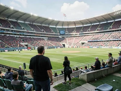 Figure standing at edge of empty stadium, 80,000 absent voices