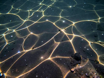 Bright focus points scattered across dark volcanic sand