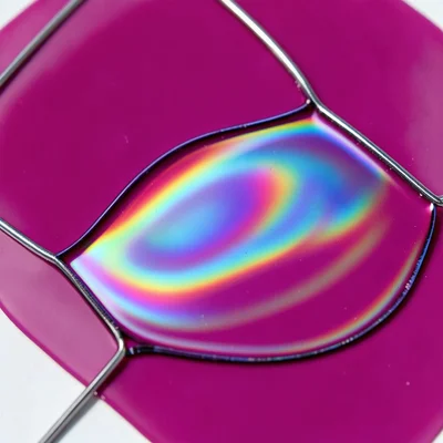 Soap film in complete stillness, perfectly even drainage creating single-color f