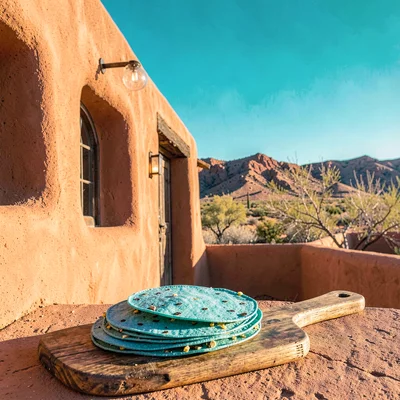 Santa Fe adobe warmth, high desert light clarity, Fresh blue corn tortillas stac