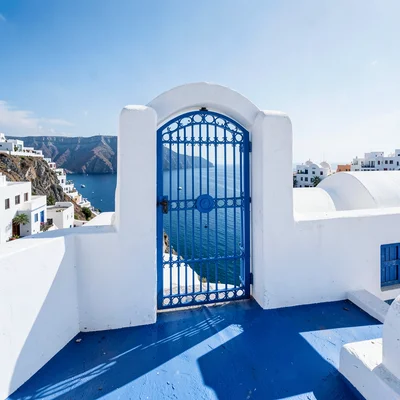 Sidi Bou Said cobalt-white, cliff-top absolute palette, Blue ironwork gate stand
