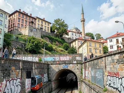 Tram emerging from hillside tunnel