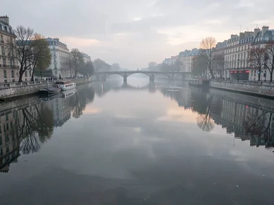 Seine surface perfectly still reflecting soft gray