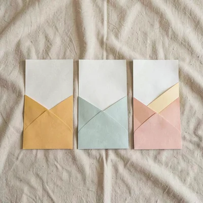Paolo-paperfold flatlay of three folded program leaflets in graduated sizes on w