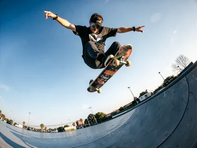 Skateboarder mid-trick with curved horizon