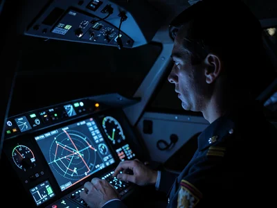 Pilot in cockpit, instrument panel lighting face, the focused navigation by digi