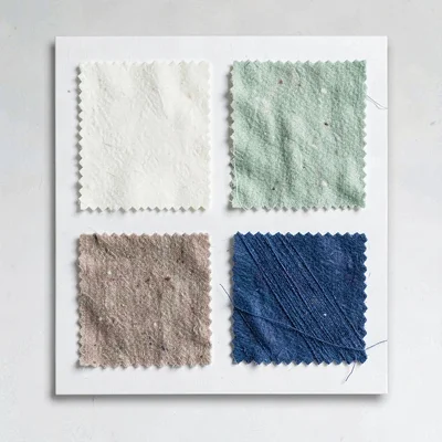 Catalog flat of a sample card with paired fabric and thread swatches