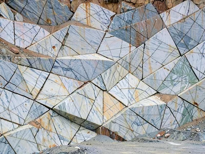 Crack patterns in quarry face creating abstract geometry