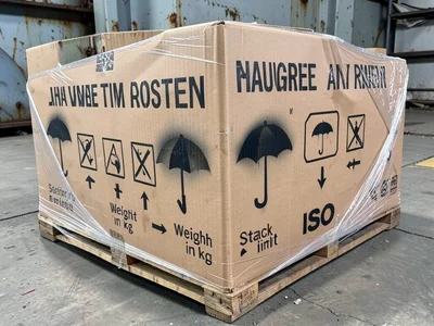 A palletized load of ceramic tiles wrapped in plastic, the outer packaging stenc