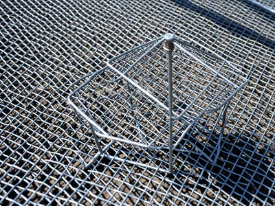 Wire mesh sculpture of beach chair and umbrella, fine gauge, shadow casting