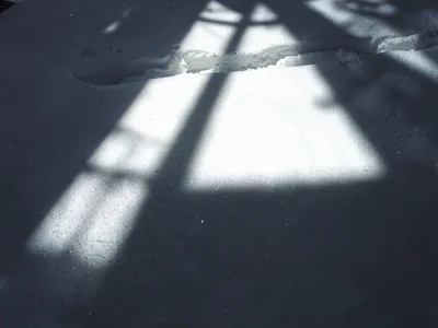 Window light creating path on snow