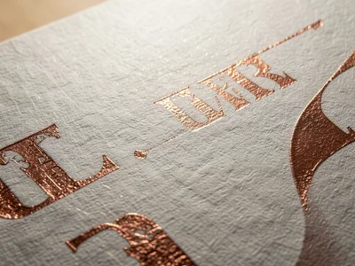 Copper foil stamp over printed texture, metallic layer partially conforming to p
